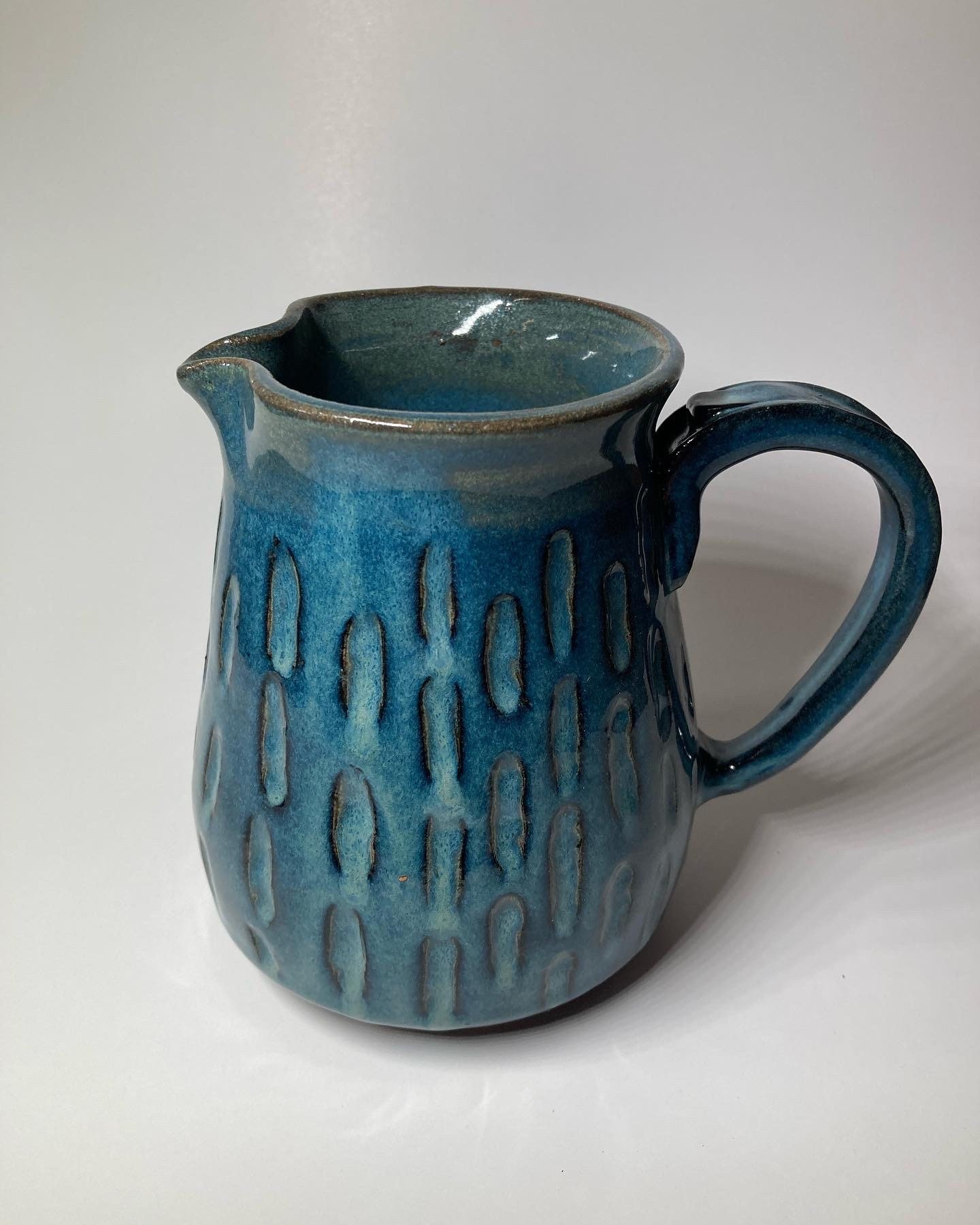 Handmade blue ceramic pitcher