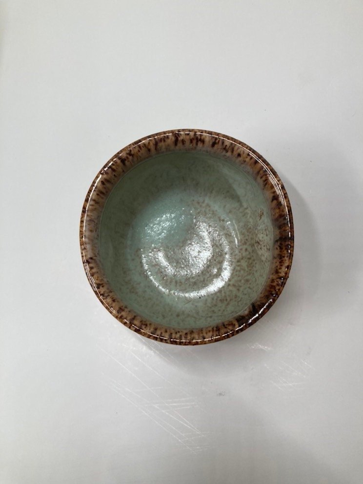 Handmade light blue handleless ceramic mug