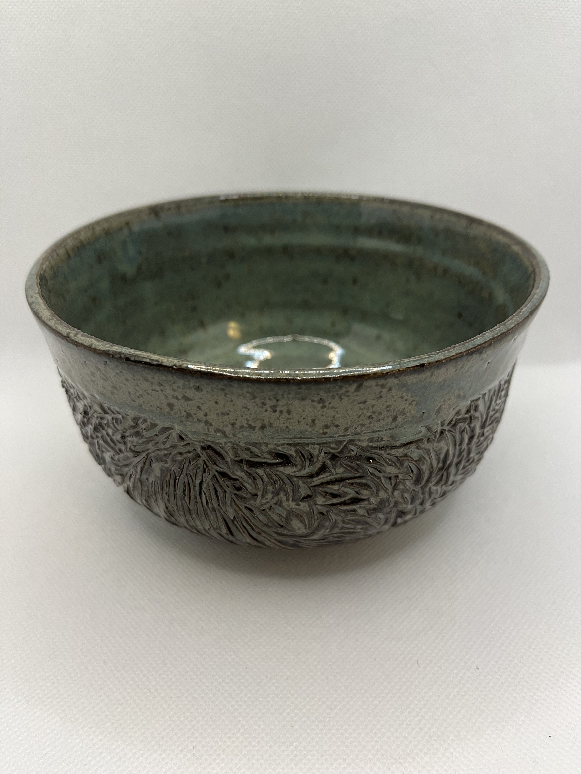 Handmade carved green ceramic bowl