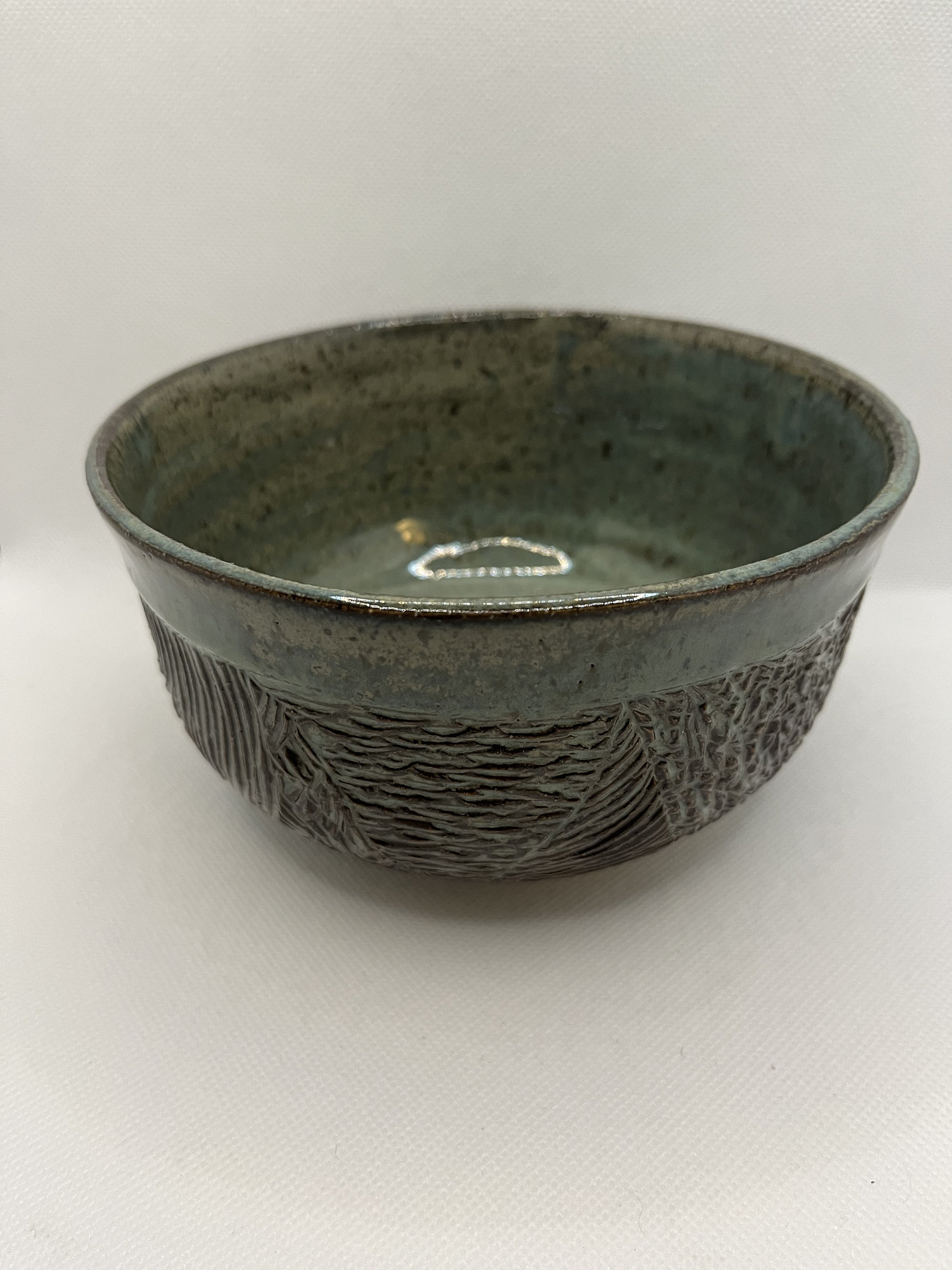 Handmade carved green ceramic bowl