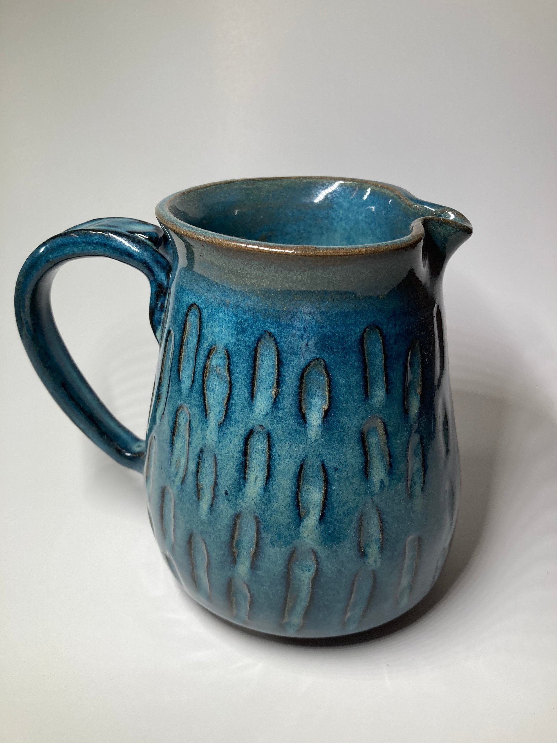 Handmade blue ceramic pitcher